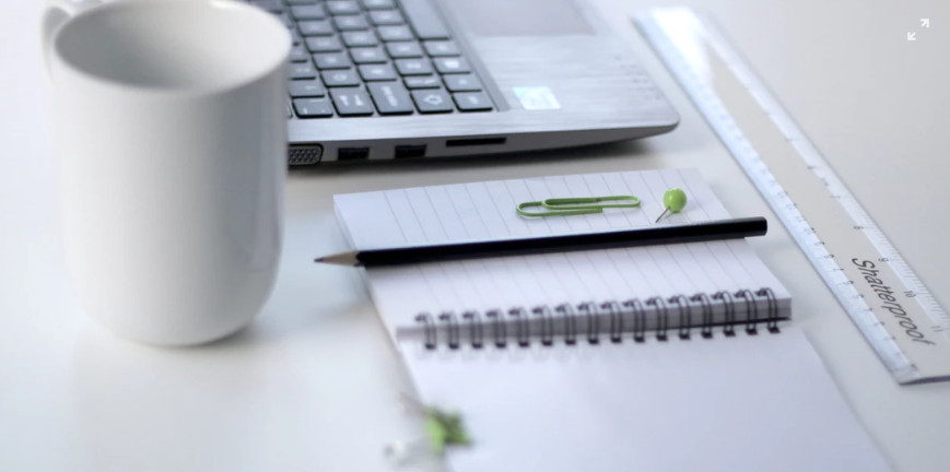 mug, notebook, pen, paperclip and ruler on the table