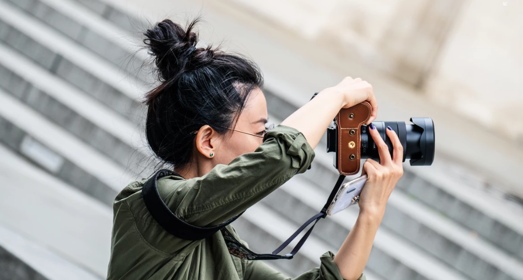 Woman taking pictures with her camera.
